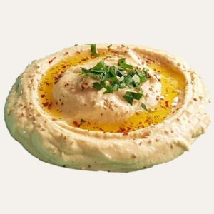 Gros plan sur un houmous artisanal crémeux, garni d'huile d'olive bio, de coriandre fraîche et de graines de sésame.