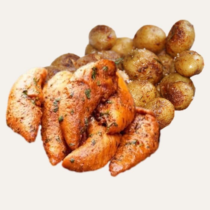 Délices du Cèdre - Traiteur Événementiel Nantes & Vitré | Restonomade Gros plan sur les tendres aiguillettes de poulet aux herbes et les pommes de terre grenailles rôties du plat libanais Délices du Cèdre